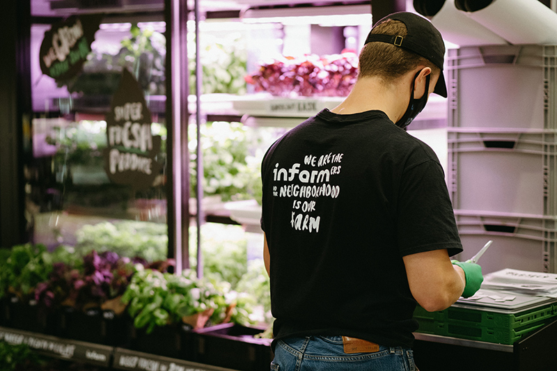 Infarm in-store farming unit with employee